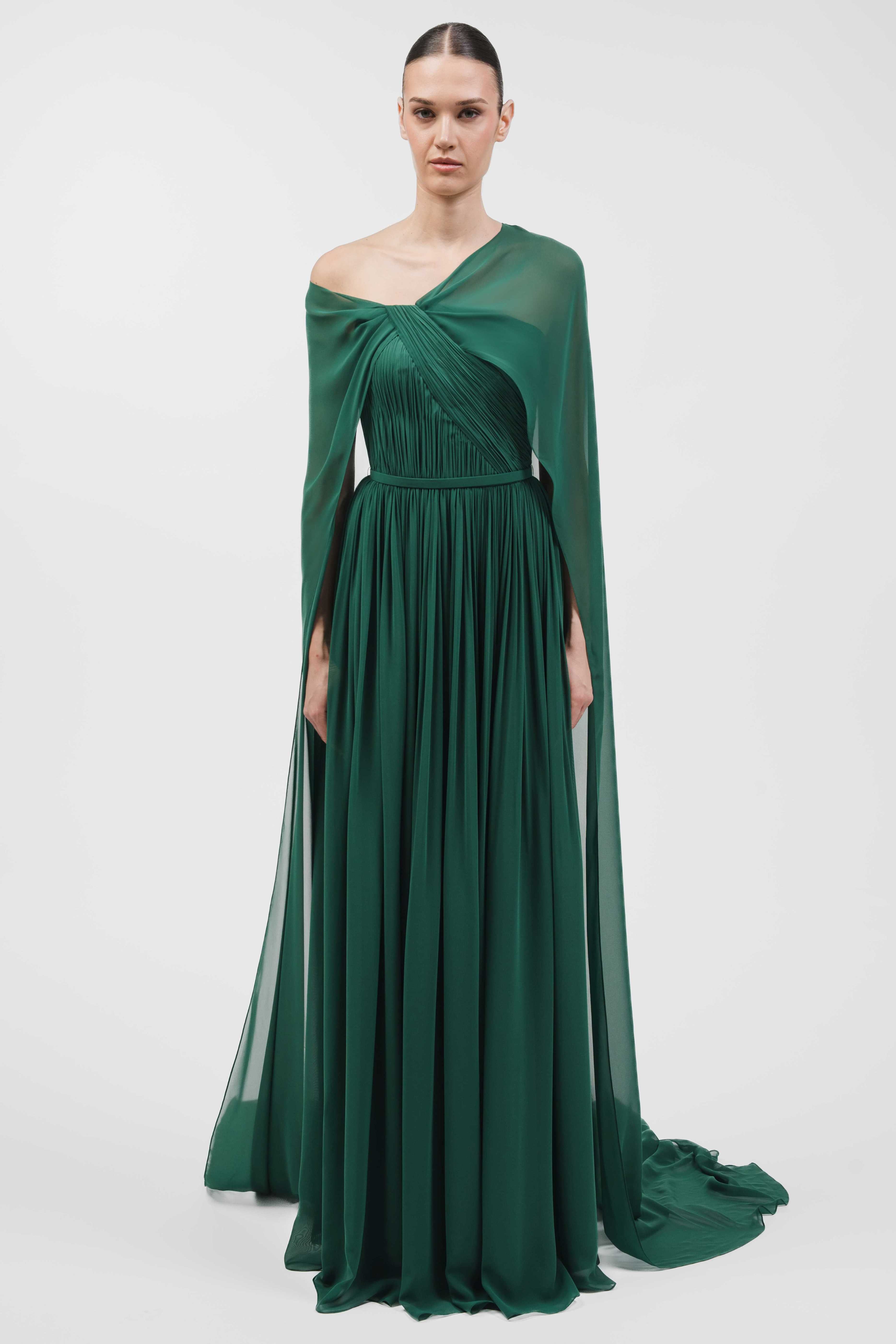 Asymmetrically Draped Muslin Gown With Cape Overlay And Flowing Silhouette.