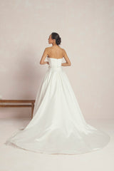 Wedding Gown With A Corset-Style Bodice And A Voluminous Skirt Designed With Multiple Panels