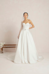 Wedding Gown With A Corset-Style Bodice And A Voluminous Skirt Designed With Multiple Panels