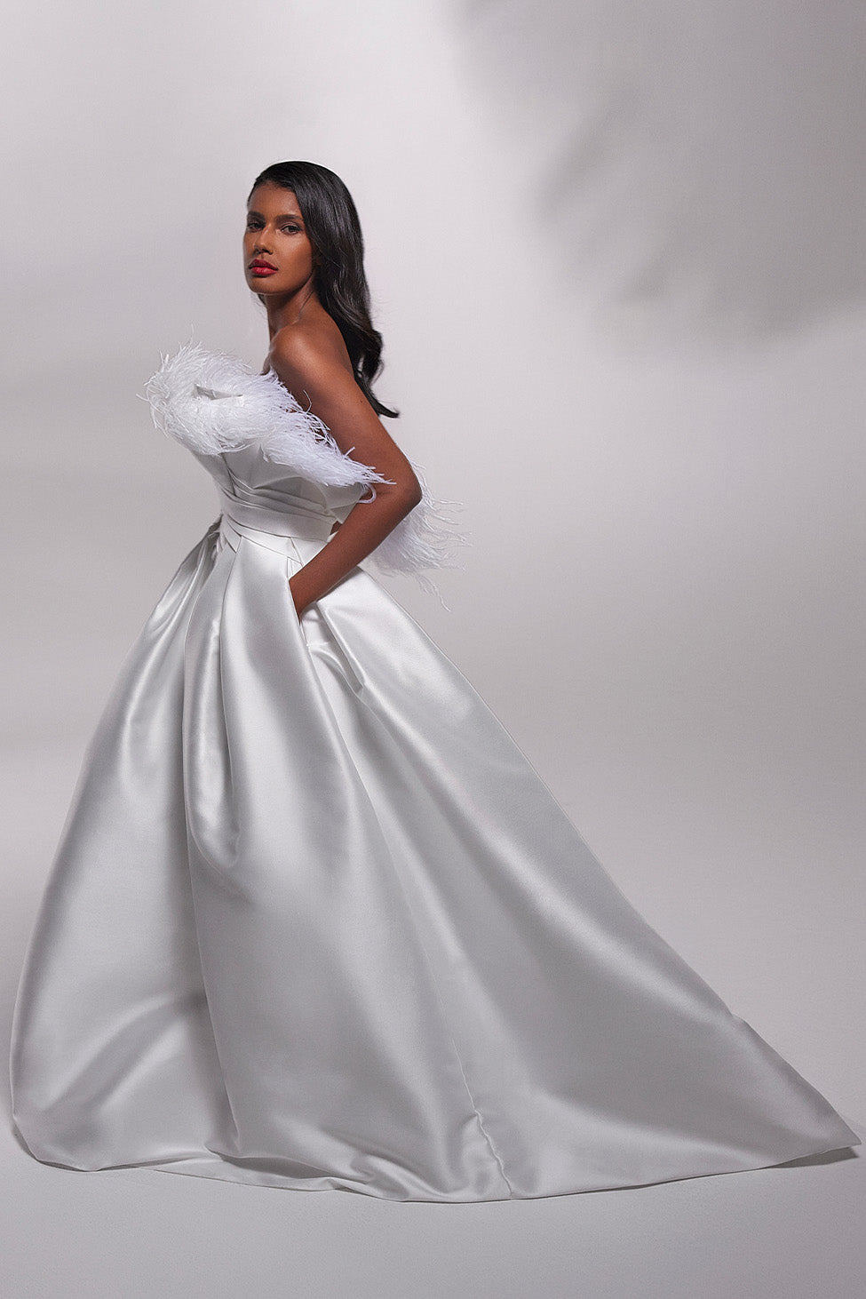 Strapless big volume satin wedding gown with extravagant feathers top