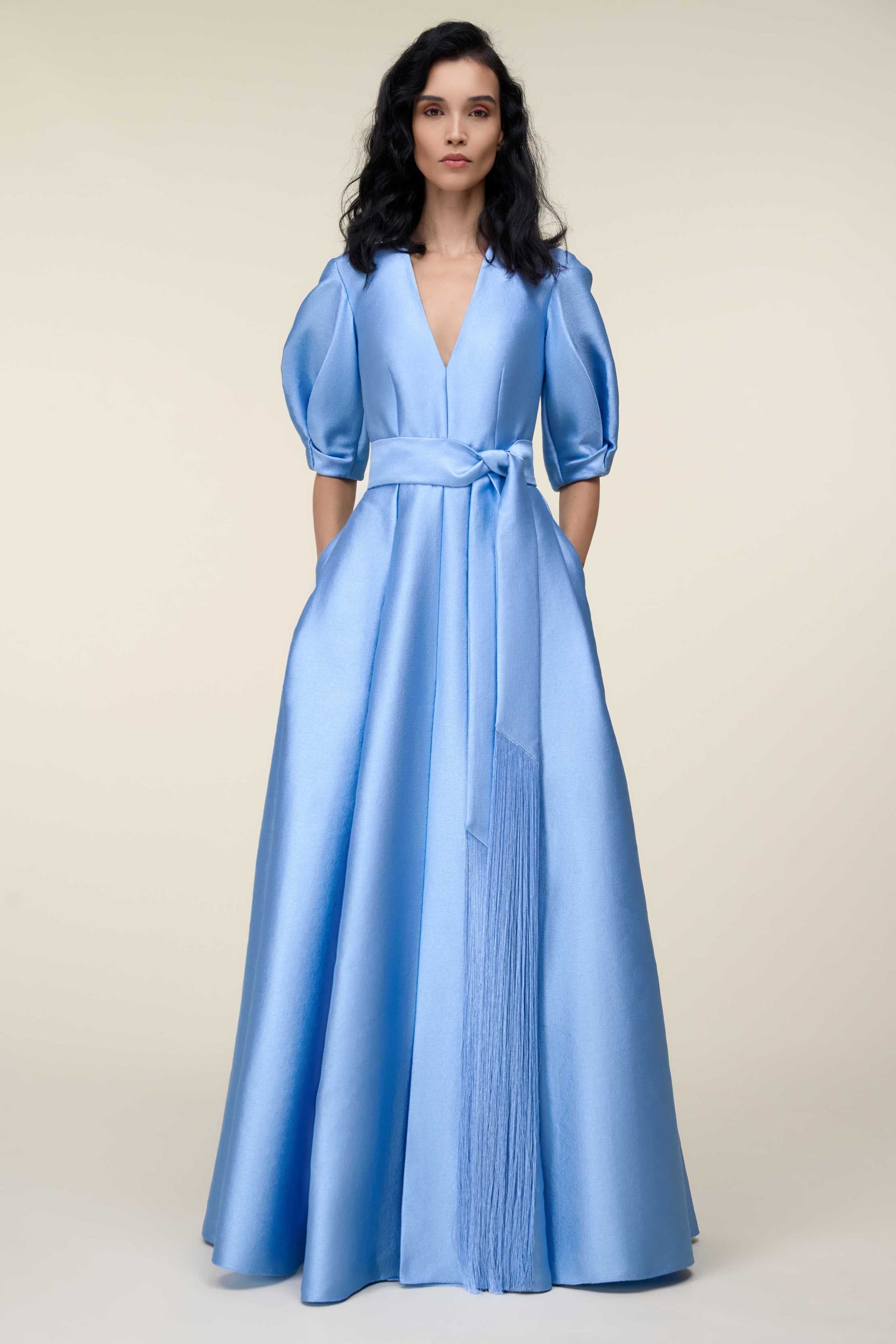 V-Neck Gown With Puff Sleeves And Fringed Sash Belt.