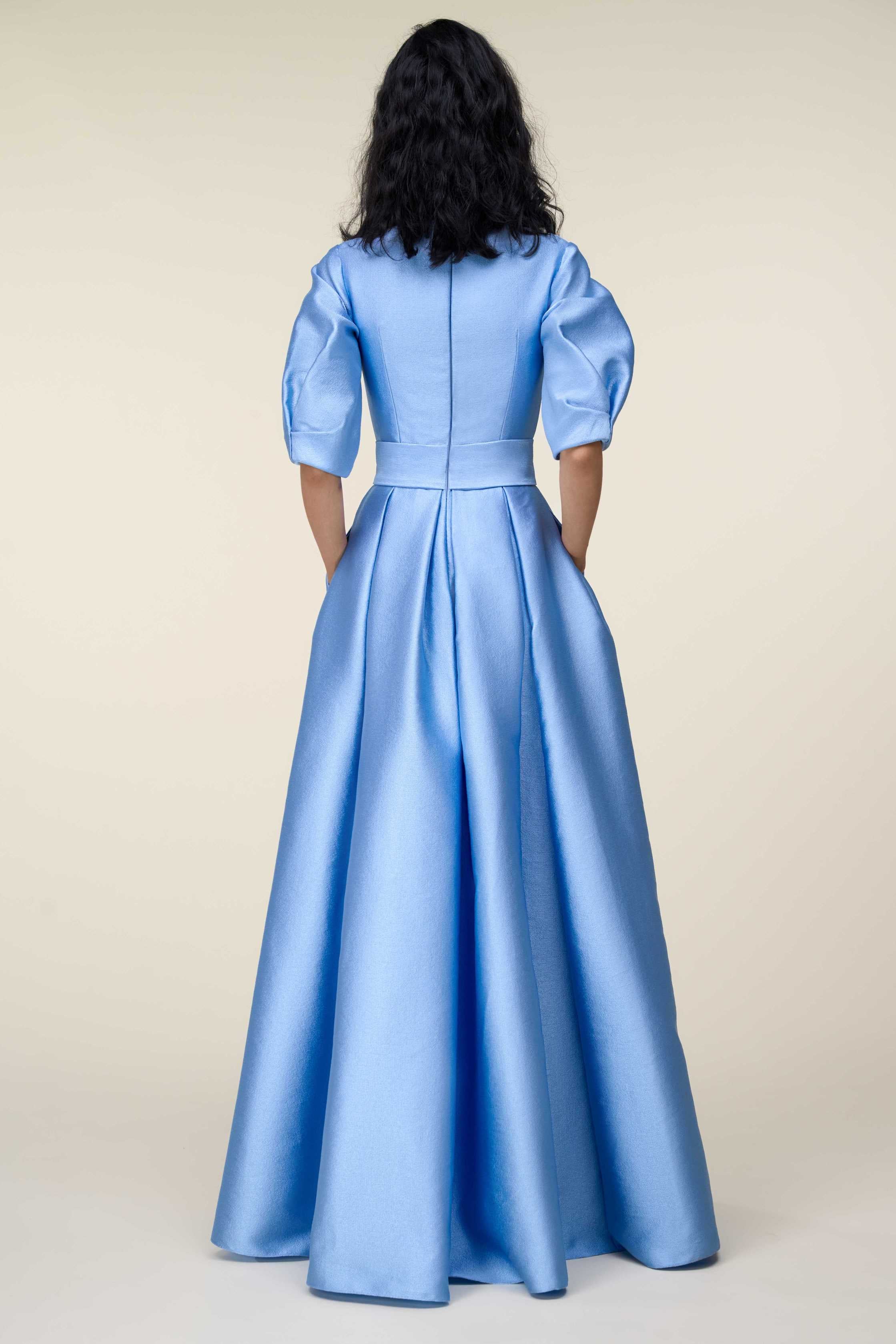 V-Neck Gown With Puff Sleeves And Fringed Sash Belt.