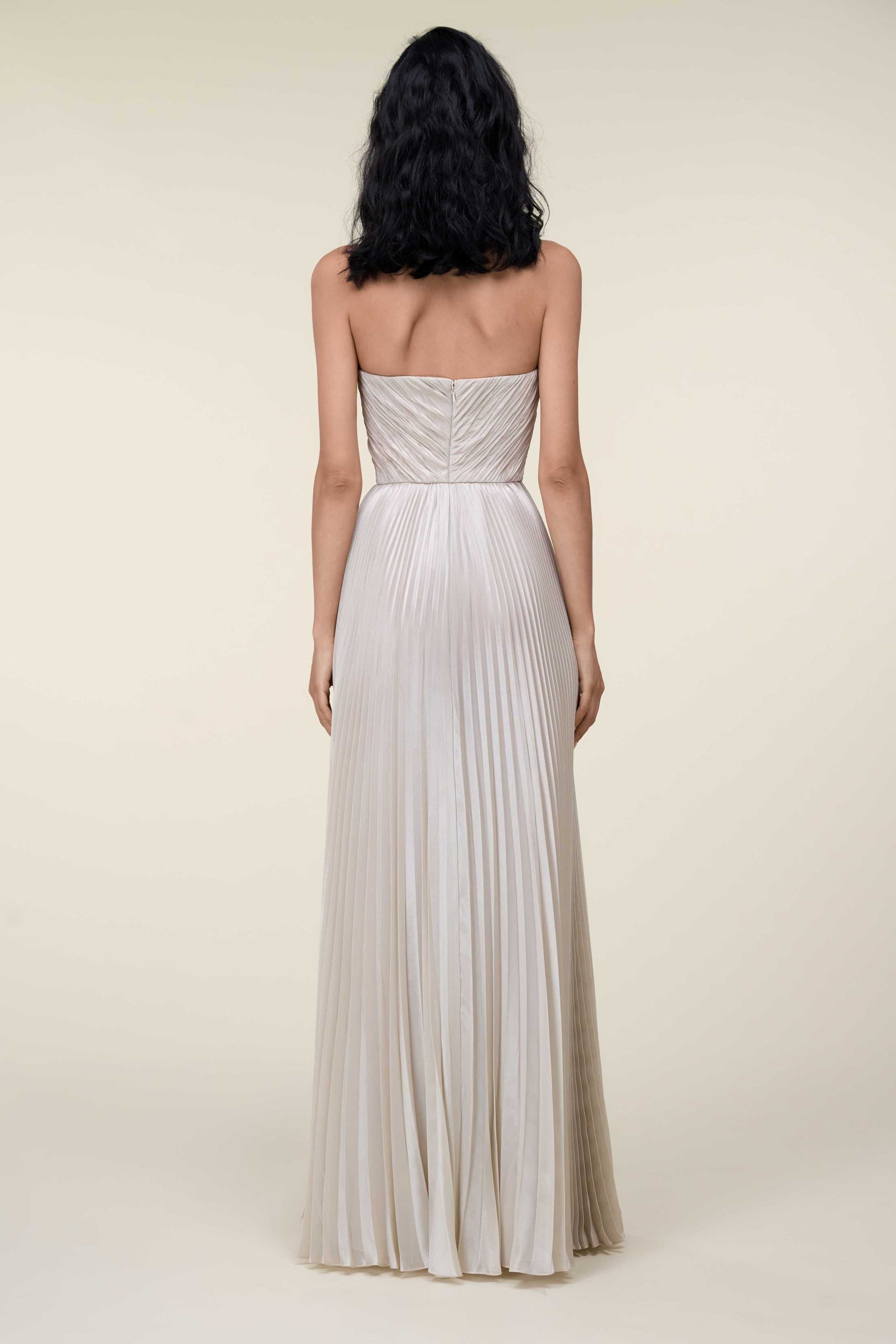 Strapless Lamé Pleated Gown With Asymmetrically Draped Bodice.