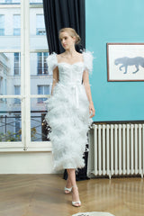 fully embellished T-length white dress decorated with feathers