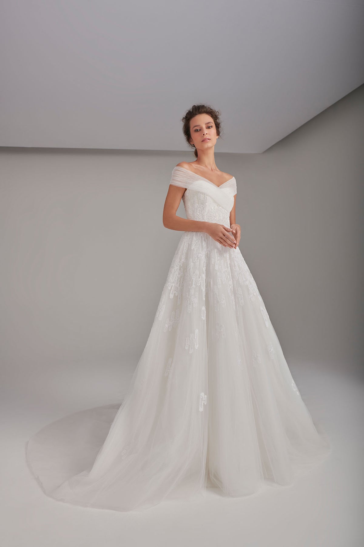 Richly embroidered off-shoulder wedding dress with long train